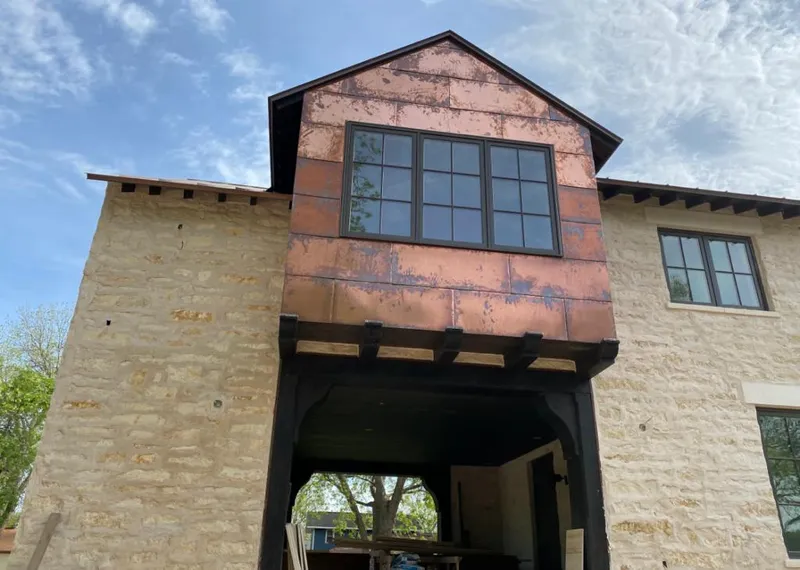 Copper metal panel facade on a stone building for Skylight Installation in Apopka