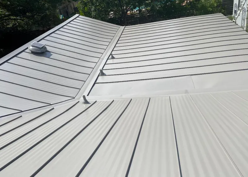 Solar attic fan installed on a metal roof for Roof Ventilation in Apopka